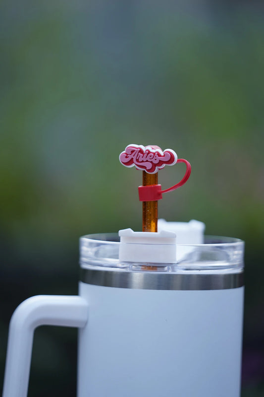 Aries zodiac straw charm attached to a glittery orange straw in a white tumbler