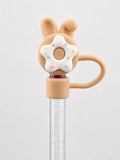 Tan bunny donut straw charm with white frosting and pastel sprinkles attached to a clear reusable straw
