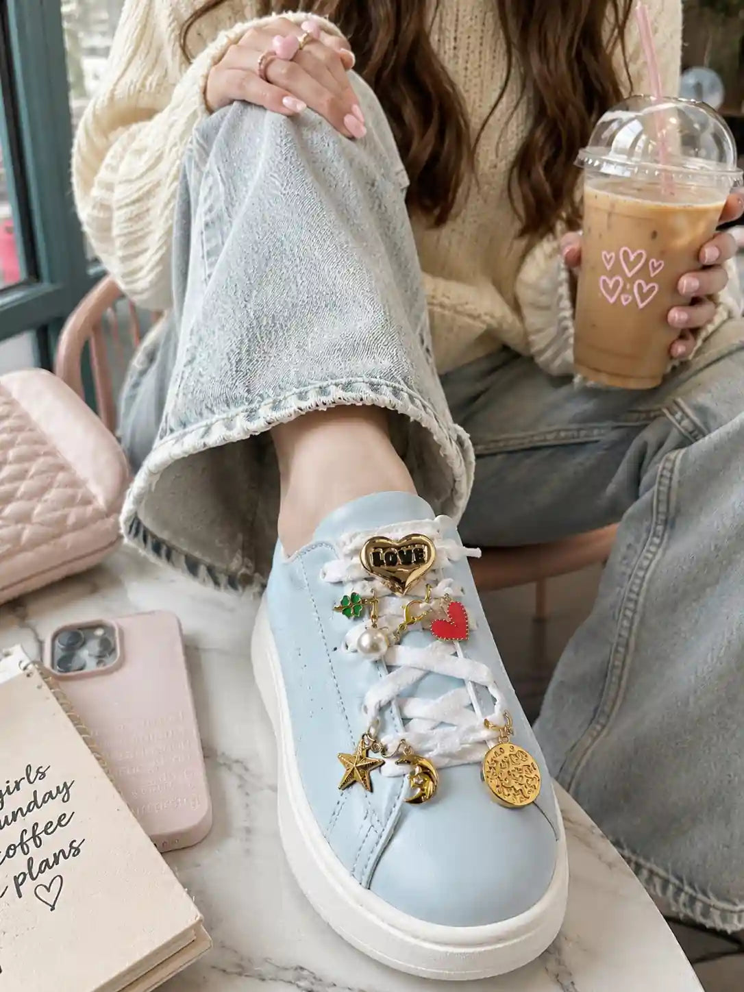 Charm’D AF Meet Cute Edit shoe charms on a light blue sneaker with heart, pearl, star, moon, clover and gold charms