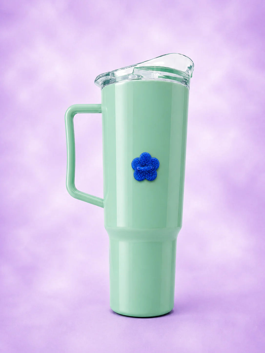 Mint green handled tumbler with a blue glitter flower bottle hook