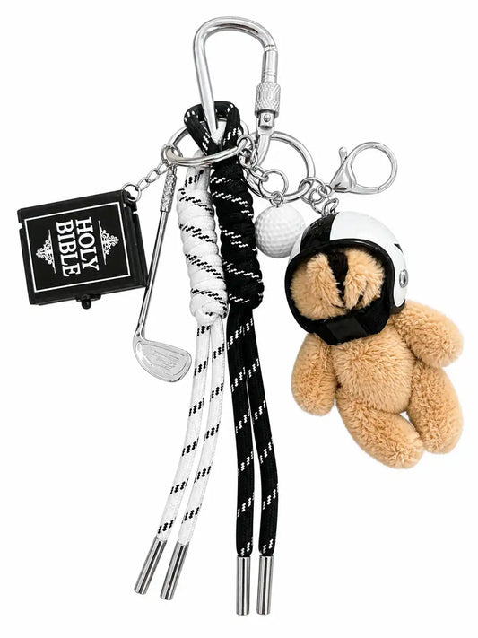 Metro Muse Teddy Bear Bag Charm with plush teddy, golf club, golf ball, Holy Bible charm and black and white cords