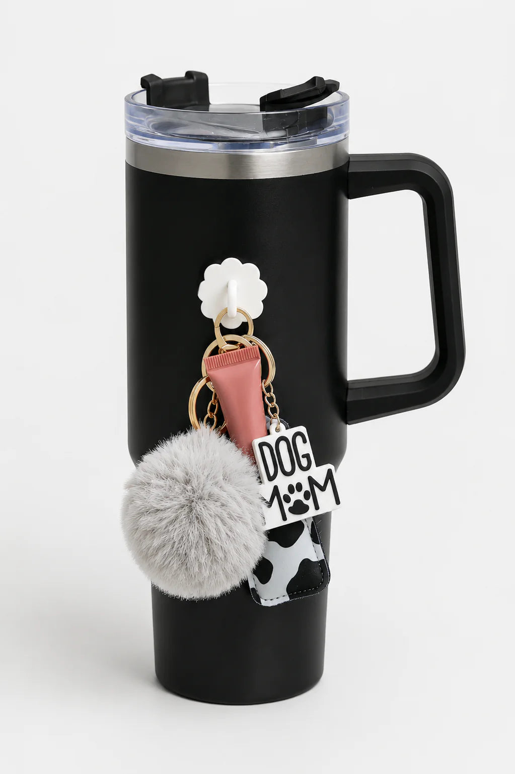 Black handled tumbler with a white flower bottle hook holding personal accessories