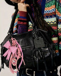 Pink Picnic Drop Heart Bag Charm attached to a black handbag