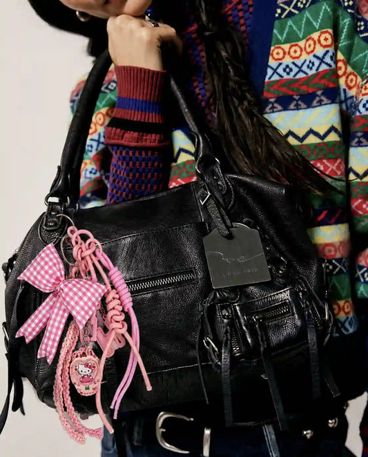 Pink Picnic Drop Heart Bag Charm attached to a black handbag
