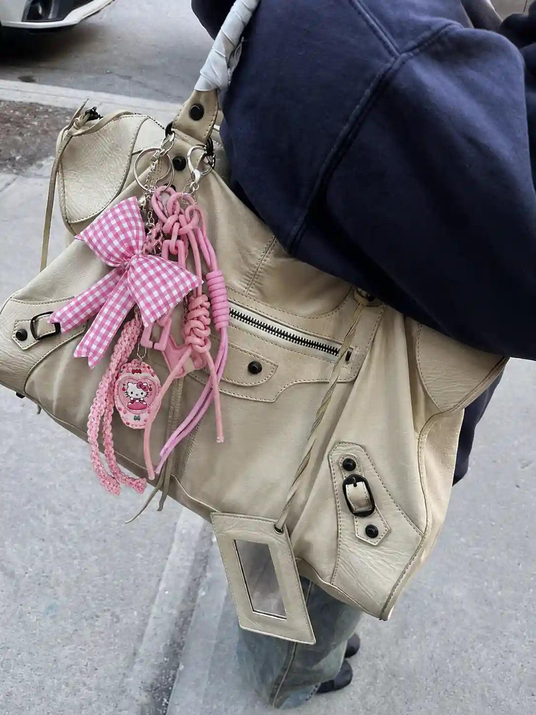 Pink Picnic Drop Heart Bag Charm styled on a cream handbag