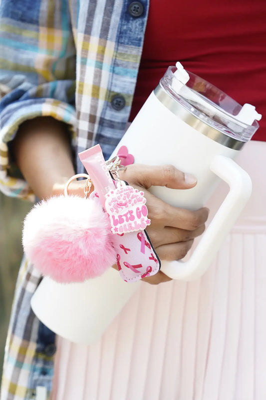 Pink Ribbon Lip Balm Holder with pink lip balm and fluffy pink pom pom attached to a white tumbler