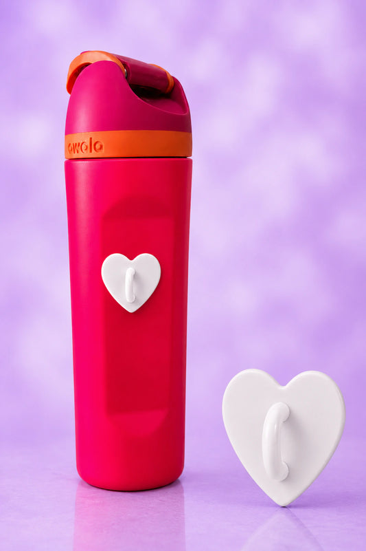 White heart-shaped charm hook attached to a bright pink water bottle, with a matching hook displayed beside it