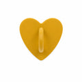 Yellow heart-shaped stick-on charm hook on a white background