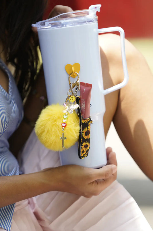 Sunflower IT Girl Bundle styled on a white water bottle with yellow pom pom, sunflower charm, lip balm holder and colourful charms