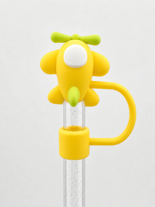 Yellow puppy straw charm with a playful dog design, green bow detail and yellow loop attached to a clear straw on a white background